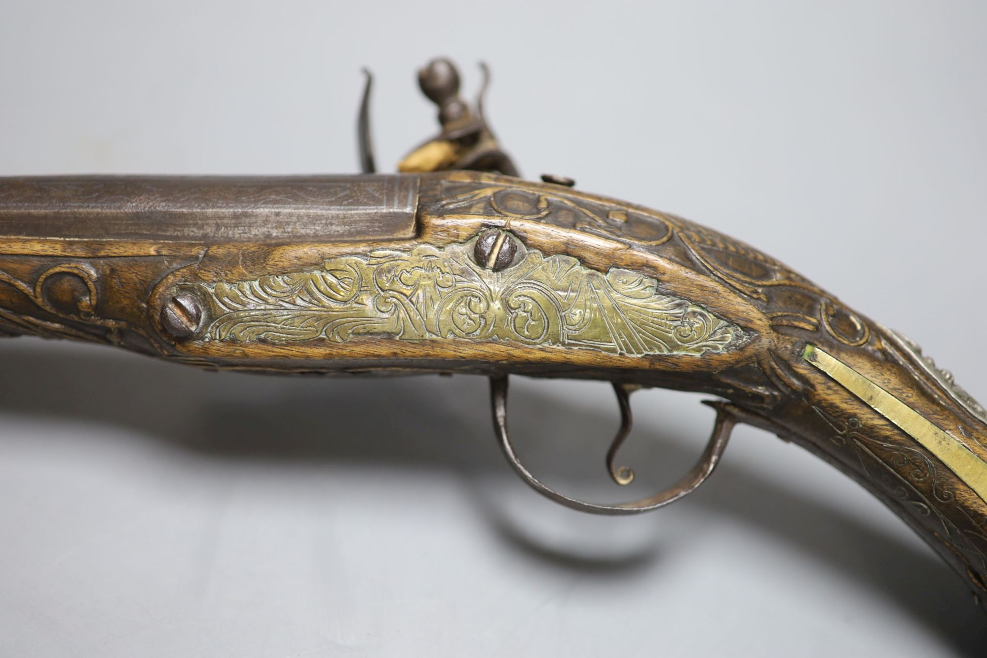 A 19th century Ottoman carved wood and brass mounted flintlock pistol, length 45cm